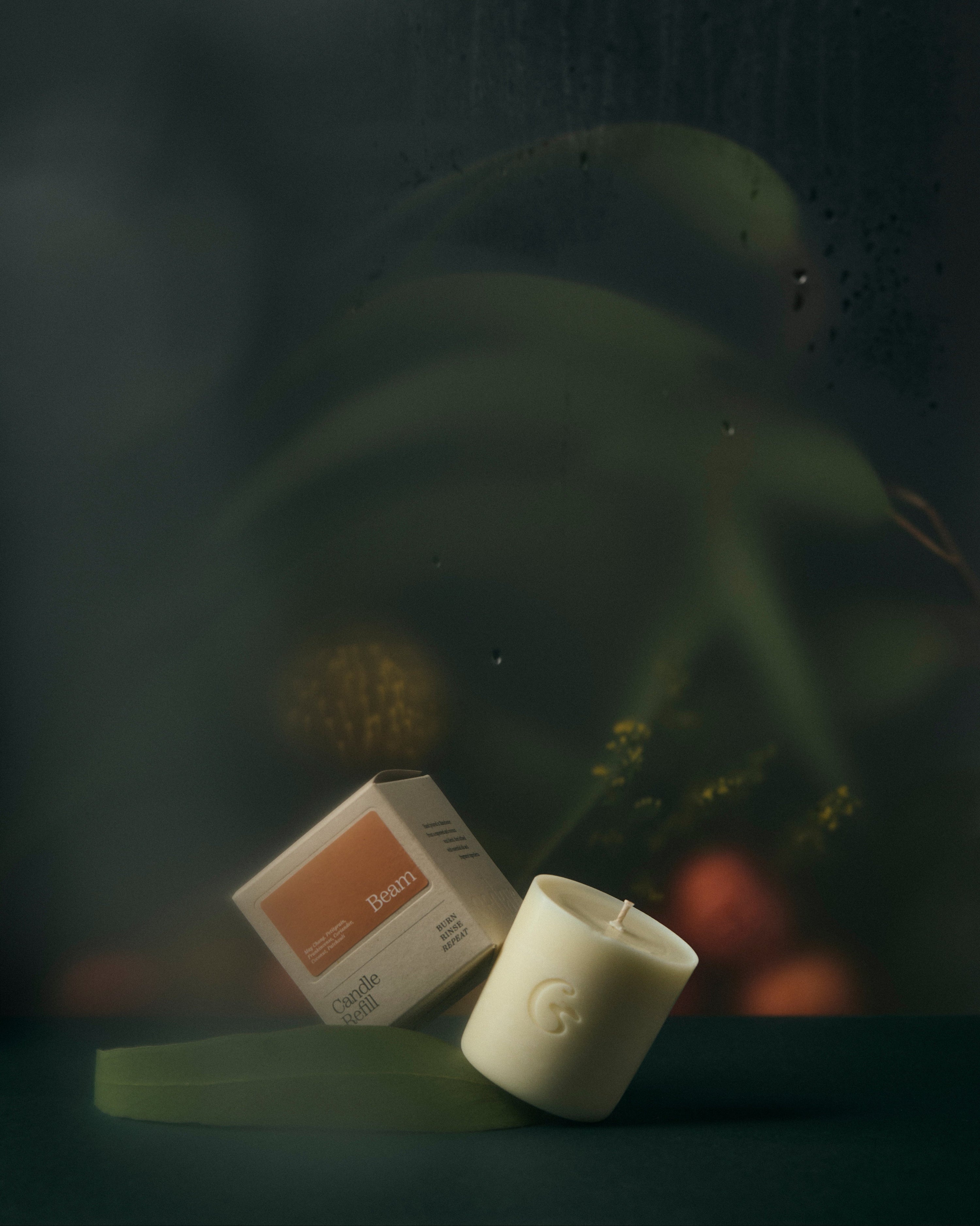Candle refill and packaging on a dark background