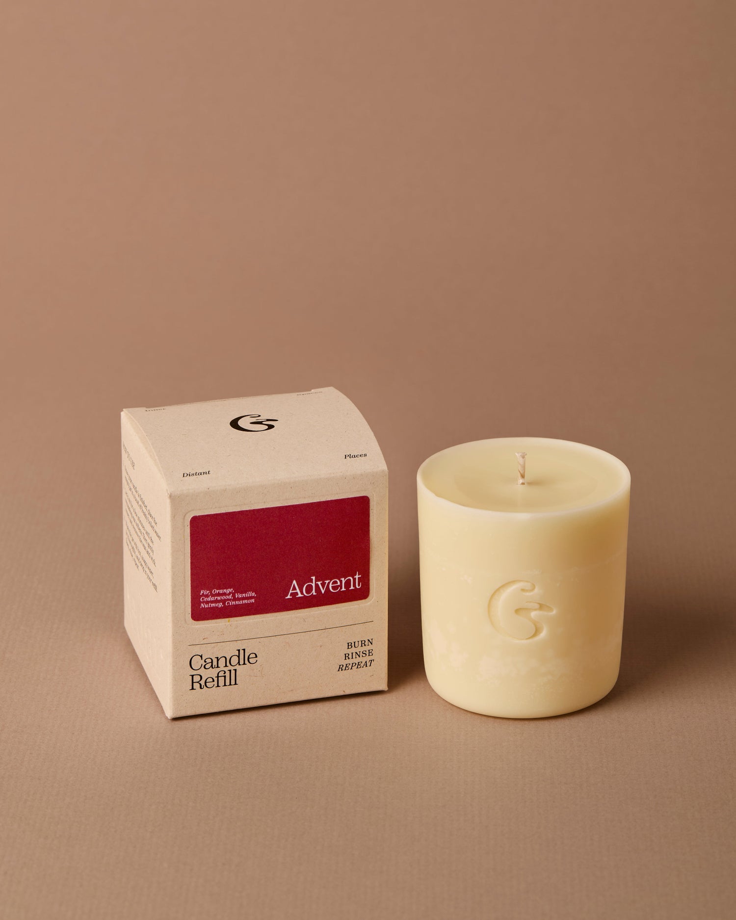 Candle refill and its packaging on a brown background