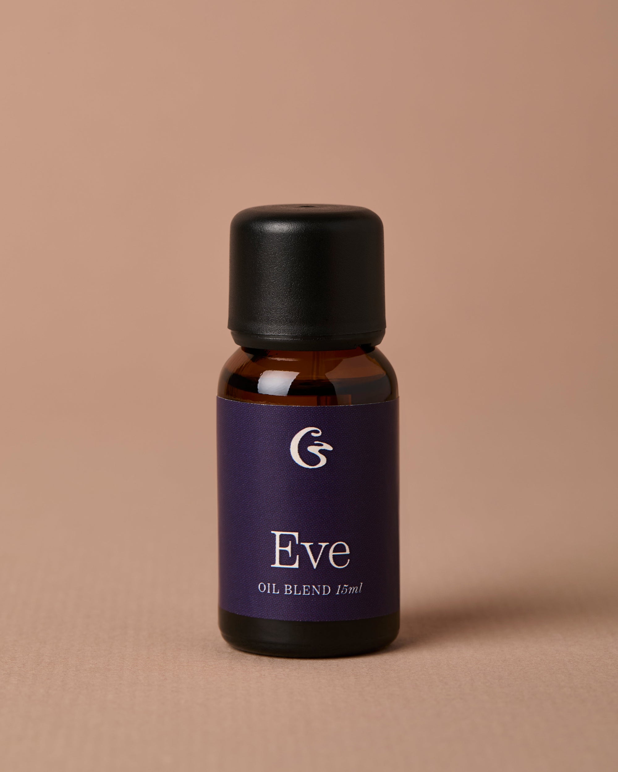 Bottle of Eve oil blend on a beige background