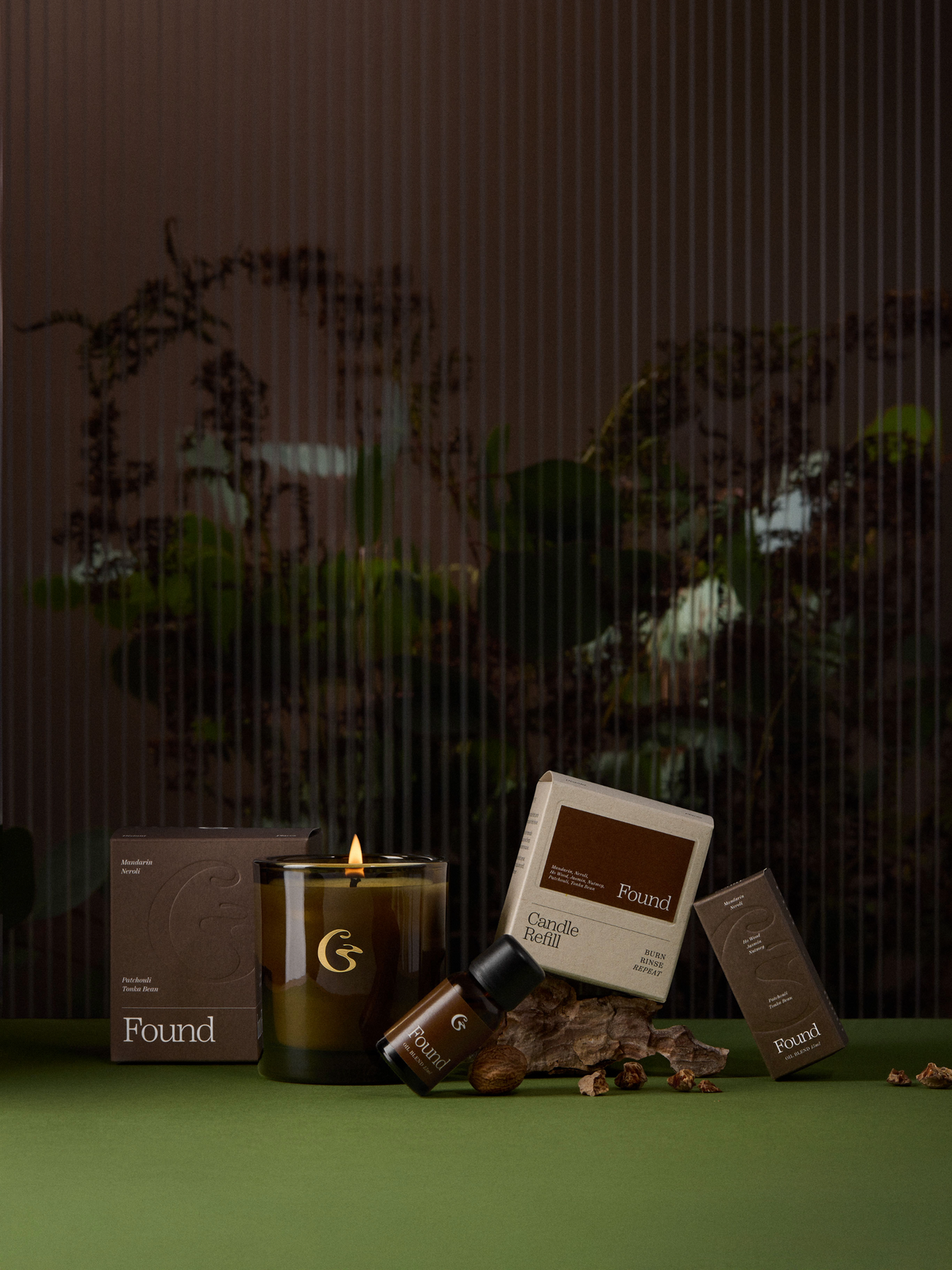 An amber lit candle and oil blend sat alongside matching boxes