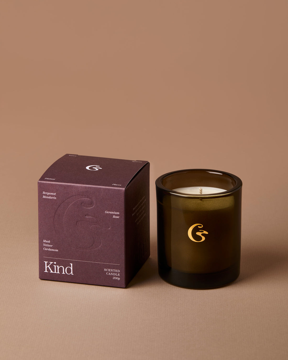 Candle and packaging with a brand logo on a brown background