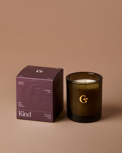 Candle and packaging with a brand logo on a brown background