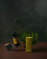 A essential oil bottle with the label rove  and a box with &