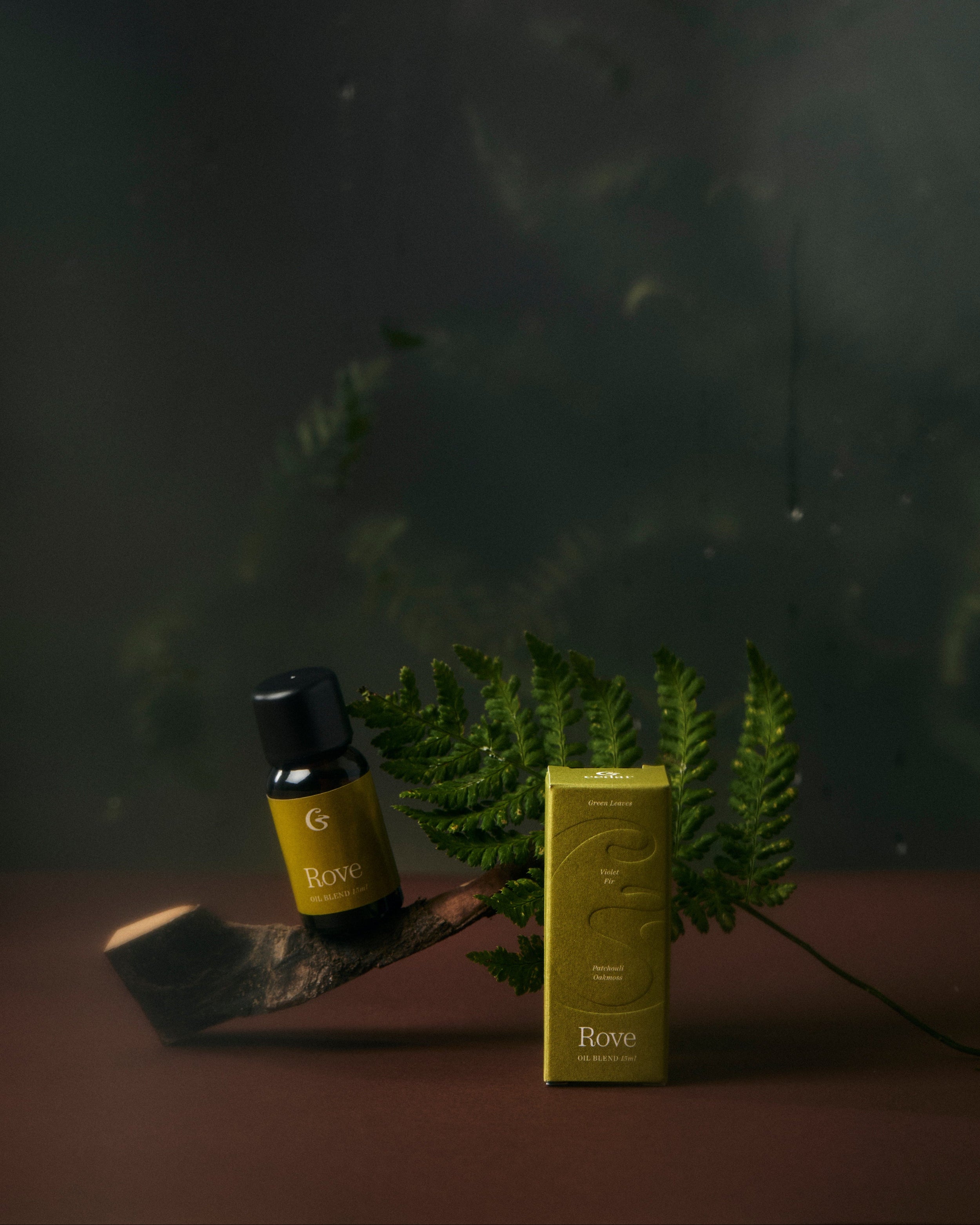 A essential oil bottle with the label rove  and a box with &